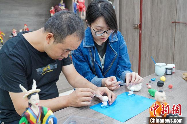 <a target='_blank'  data-cke-saved- >中新社</a>記者(右)現(xiàn)場(chǎng)體驗(yàn)面塑制作過(guò)程?！￡悹?zhēng)強(qiáng) 攝